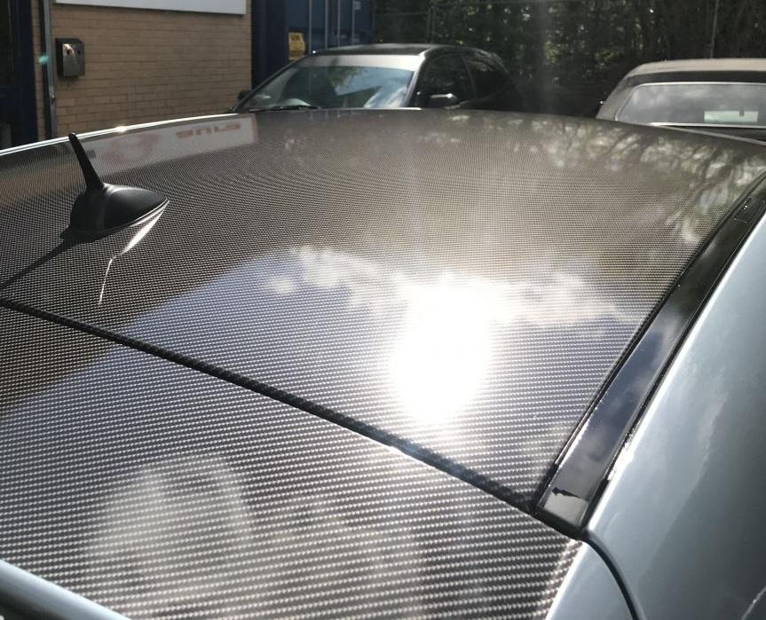 Roof of car wrapped in carbon fiber